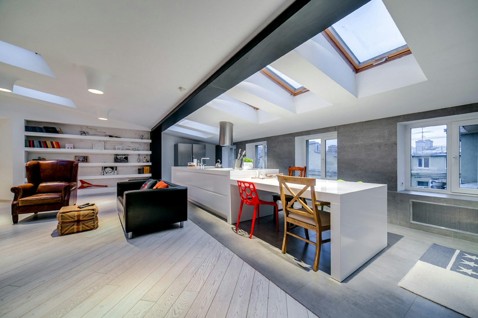 a kitchen with a table and chairs and a skylight